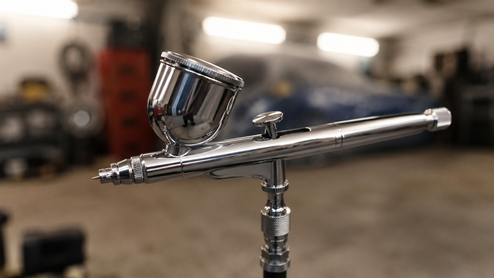 Professional airbrush ready for custom paintwork in the workshop